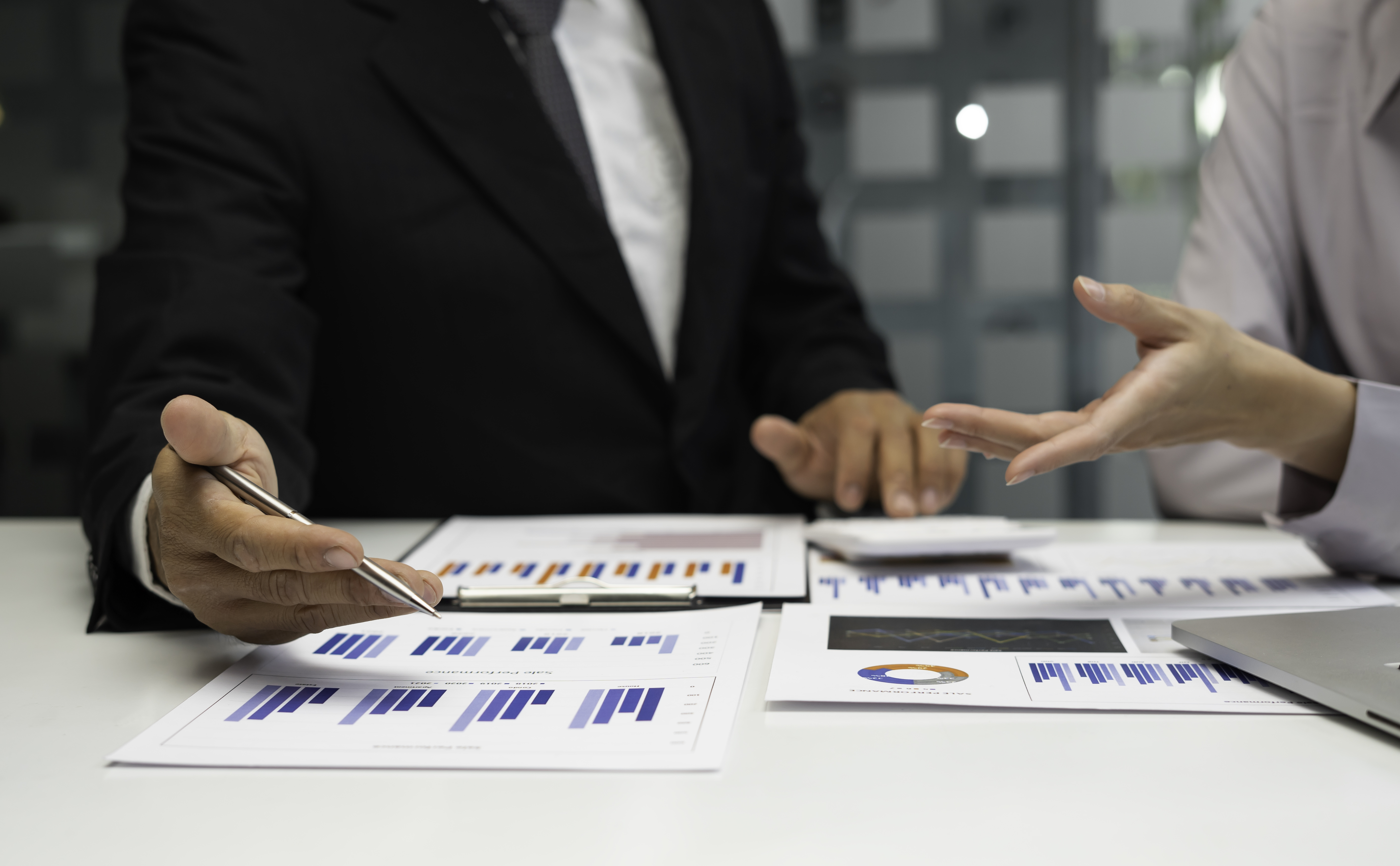 An Asian male finance chief and partner are meeting to discuss business plans and pre-business marke